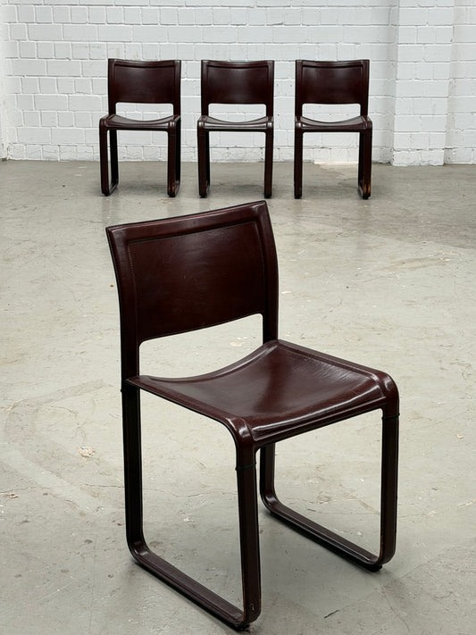 A Set of 4 Matteo Grassi - Sinistra - chairs in Burgundi leather designed by Tito Agnolio