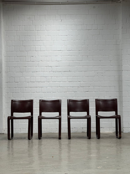 A Set of 4 Matteo Grassi - Sinistra - chairs in Burgundi leather designed by Tito Agnolio